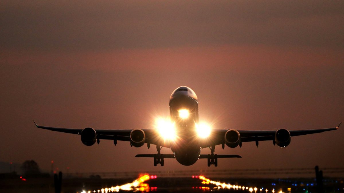 Commercial passenger airliner parked at an airport terminal gate during daytime