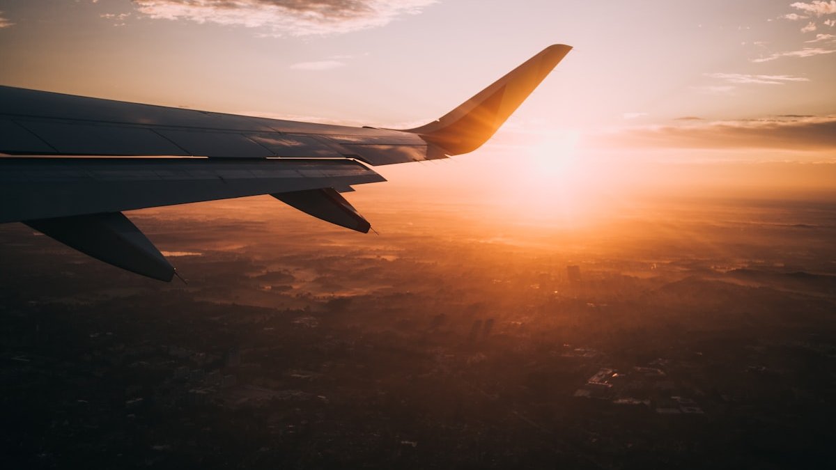 Delta aircraft taxiing on the runway during sunset at a hub airport