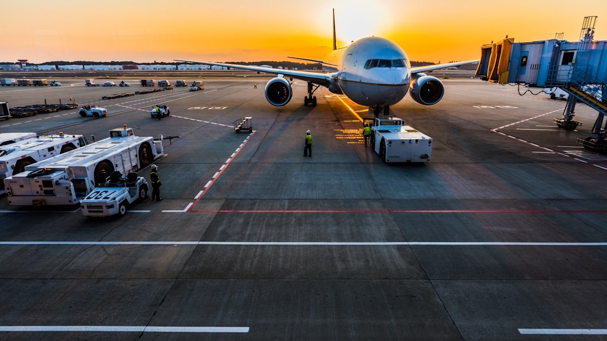 Overhead bin compartment full of carry-on suitcases inside commercial airplane
